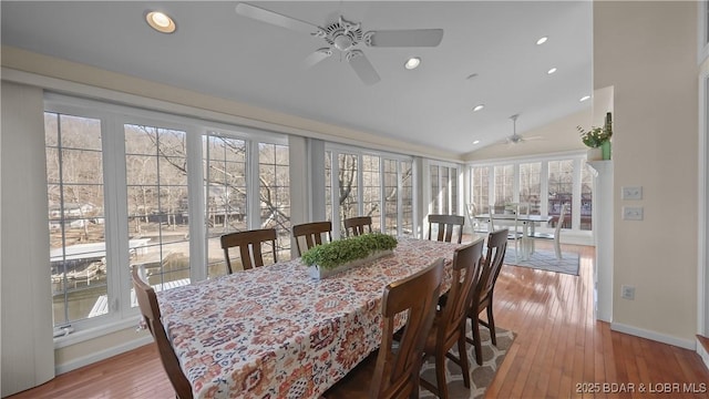 dining space with hardwood / wood-style flooring, vaulted ceiling, and ceiling fan