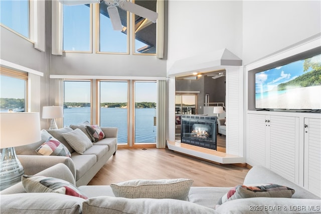 701 Cedar Rd Unit 3A, Lake Ozark, MO 65049 - living room with a glass covered fireplace, wood finished floors, and a ceiling fan