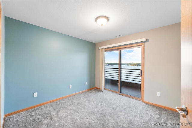 spare room featuring visible vents, baseboards, and carpet floors