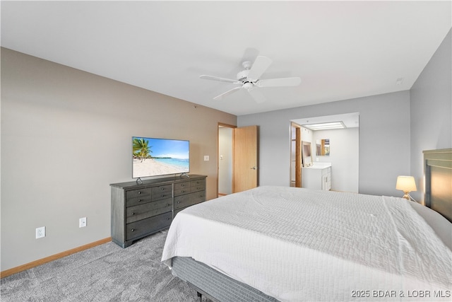 bedroom with connected bathroom, baseboards, carpet floors, and a ceiling fan