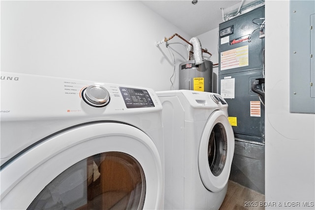 washroom with washer and clothes dryer, laundry area, electric water heater, and wood finished floors