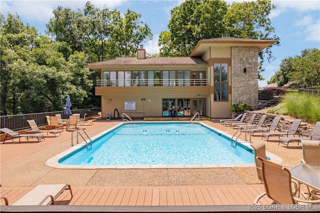 pool featuring a patio area and fence