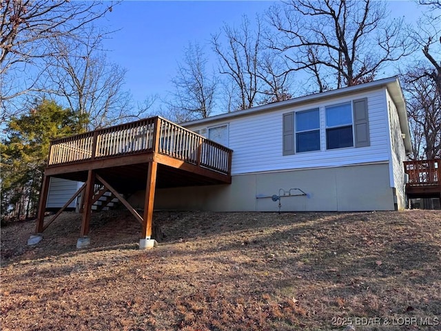 back of property featuring a deck