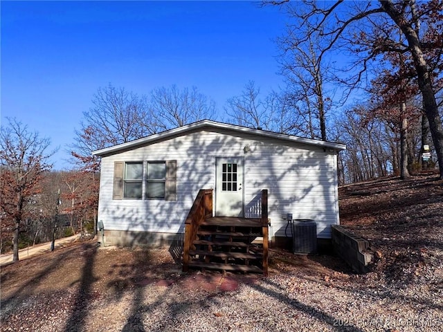 rear view of property with cooling unit