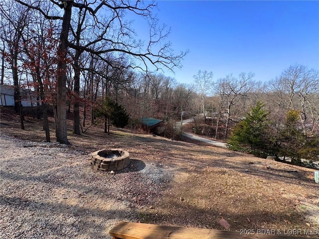 view of yard with an outdoor fire pit