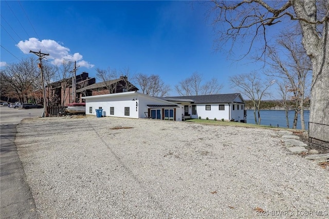 view of front of house with a water view