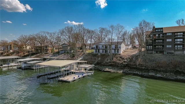 dock area with a residential view and a water view