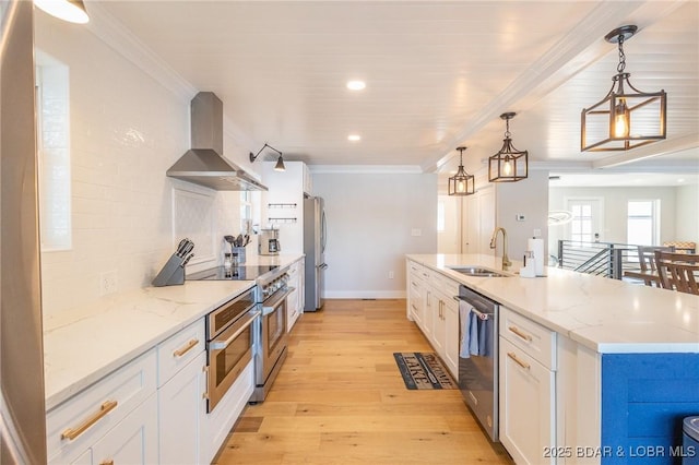 5885 Baydy Peak Rd, Osage Beach, MO 65065 - kitchen with wall chimney range hood, a sink, appliances with stainless steel finishes, white cabinets, and light wood-style flooring