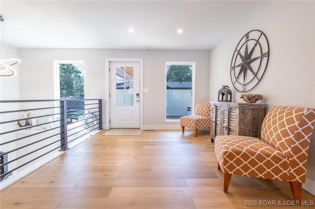 foyer entrance featuring recessed lighting, baseboards, plenty of natural light, and hardwood / wood-style floors