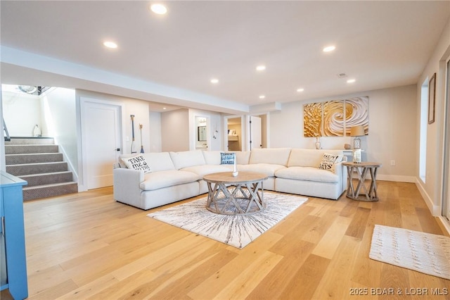 living area with stairway, recessed lighting, light wood-style floors, and baseboards