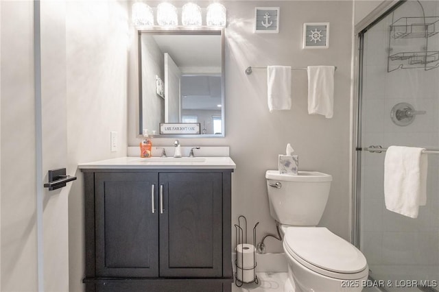 full bath featuring vanity, a shower stall, and toilet