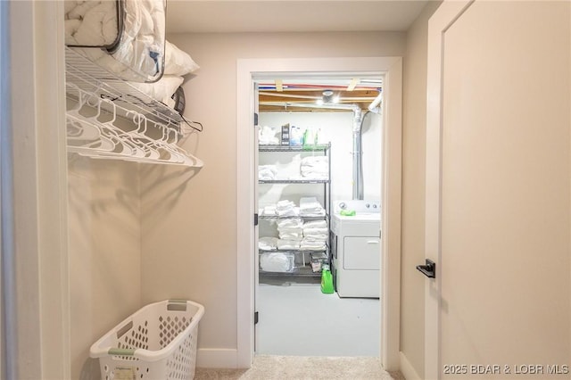 spacious closet with washer / dryer and carpet