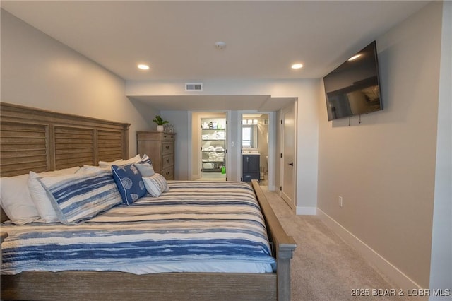 bedroom with visible vents, recessed lighting, connected bathroom, carpet, and baseboards