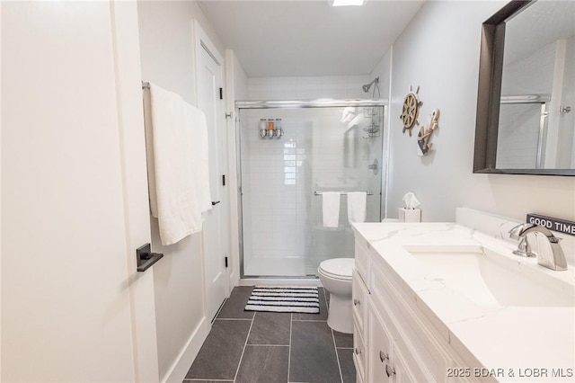 full bathroom featuring vanity, tile patterned floors, toilet, and a stall shower