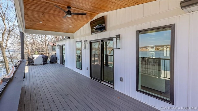 wooden deck with ceiling fan and a wall unit AC