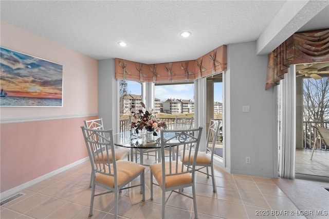 dining room featuring visible vents, a textured ceiling, recessed lighting, light tile patterned floors, and baseboards