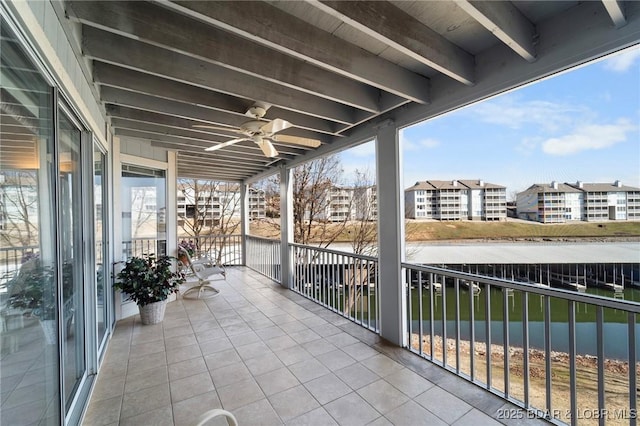 view of patio / terrace with a balcony, a water view, and ceiling fan