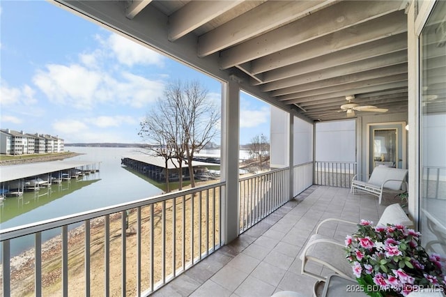 balcony featuring a ceiling fan and a water view