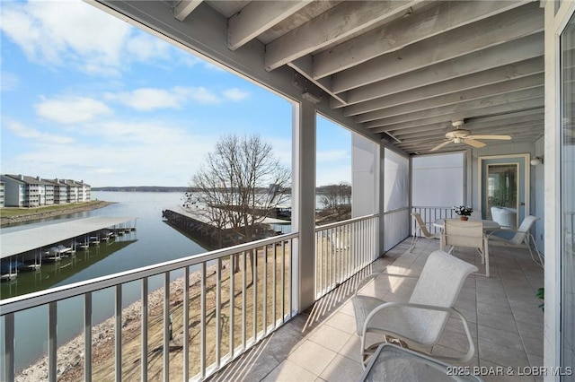 balcony with a water view and ceiling fan