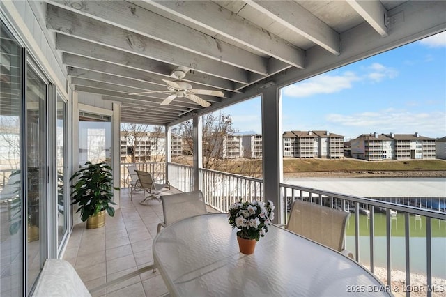 balcony with outdoor dining area and ceiling fan