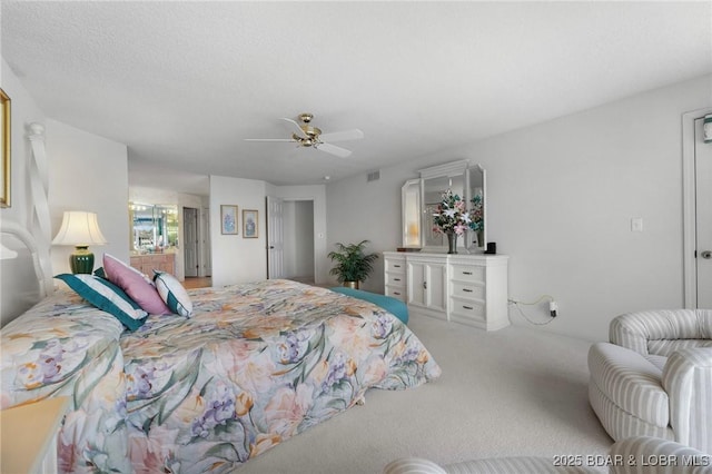 bedroom featuring visible vents, a ceiling fan, and carpet flooring