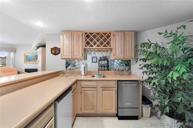 bar with dishwasher, a textured ceiling, wet bar, and a sink