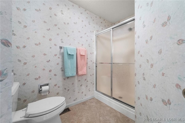 full bath featuring baseboards, toilet, a shower stall, and wallpapered walls