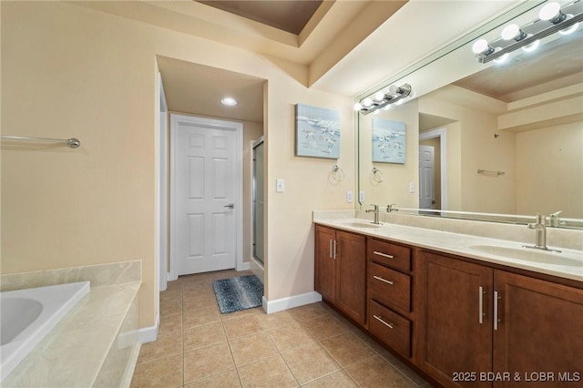 bathroom featuring tile patterned floors, double vanity, a stall shower, and a sink