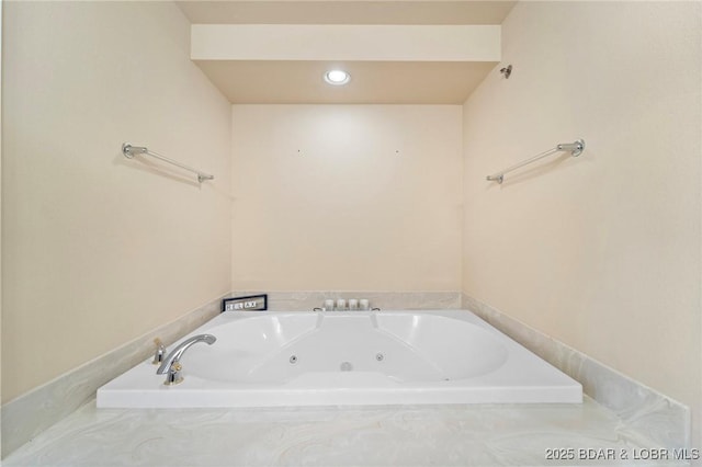 bathroom featuring a tub with jets