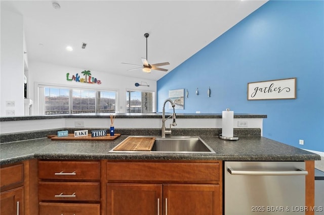 kitchen with brown cabinets, a sink, stainless steel dishwasher, dark countertops, and ceiling fan