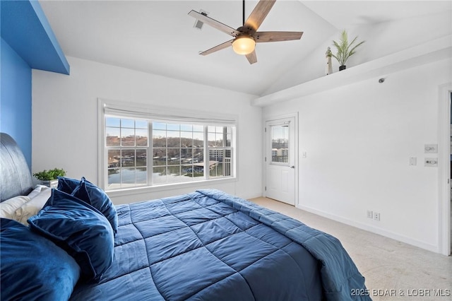 carpeted bedroom featuring lofted ceiling, a ceiling fan, and baseboards