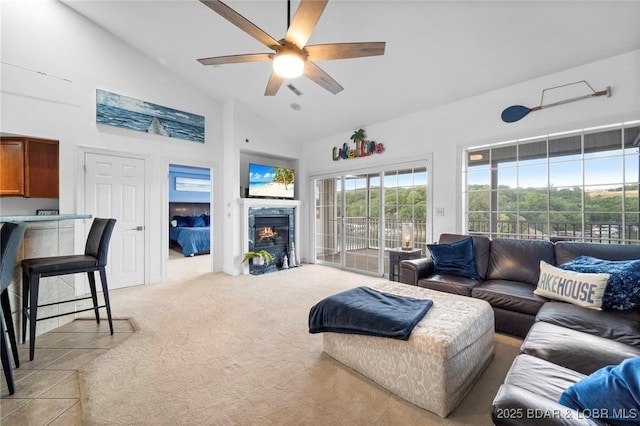 68 Lighthouse Rd Unit 344, Lake Ozark, MO 65049 - living area featuring high vaulted ceiling, ceiling fan, light carpet, and a glass covered fireplace