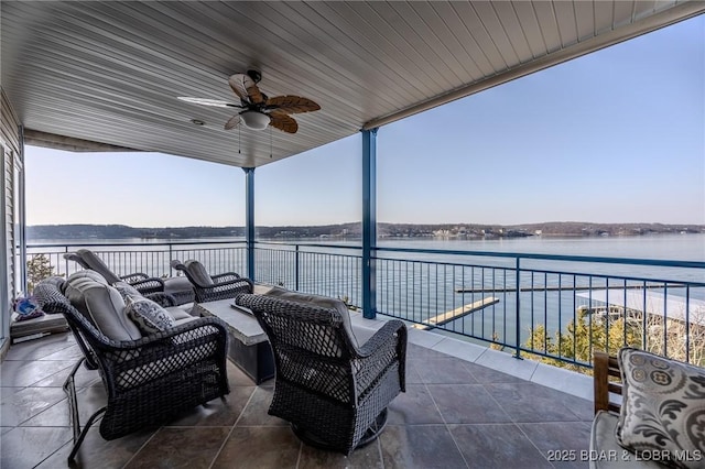 view of patio featuring an outdoor hangout area, a balcony, a ceiling fan, and a water view