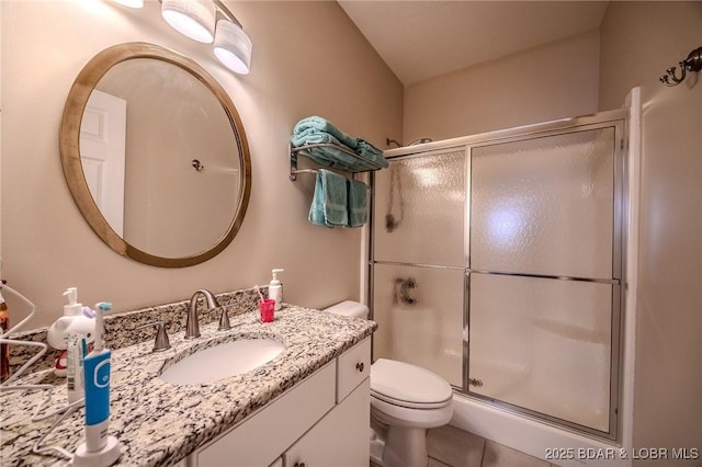 full bath with toilet, tile patterned floors, an enclosed shower, and vanity