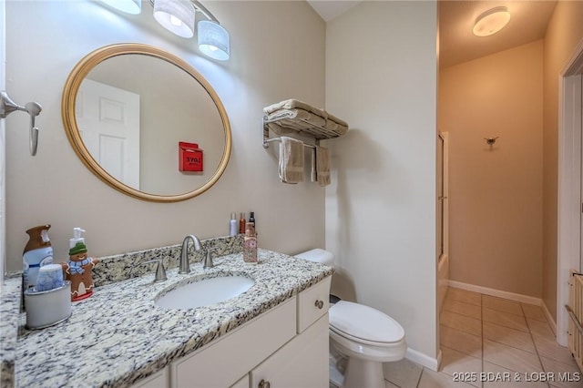 bathroom with tile patterned flooring, baseboards, toilet, enclosed tub / shower combo, and vanity