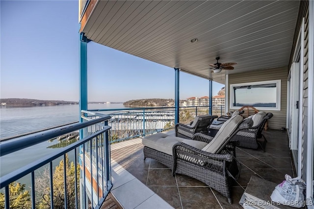 balcony with ceiling fan and a water view