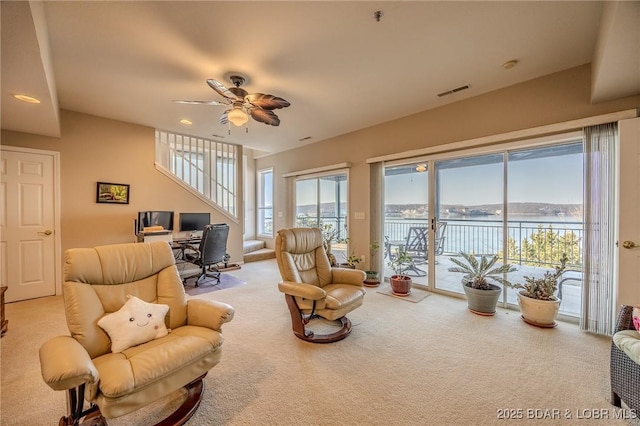 living area featuring carpet, recessed lighting, a ceiling fan, and visible vents