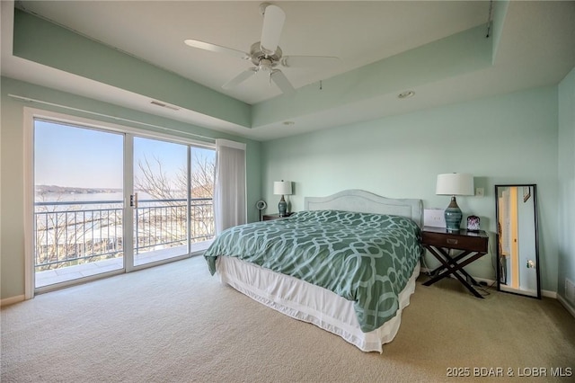 bedroom with visible vents, a raised ceiling, access to outside, carpet floors, and baseboards