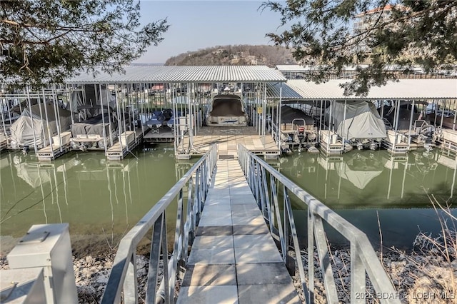 dock area with a water view and boat lift