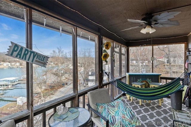 unfurnished sunroom featuring ceiling fan