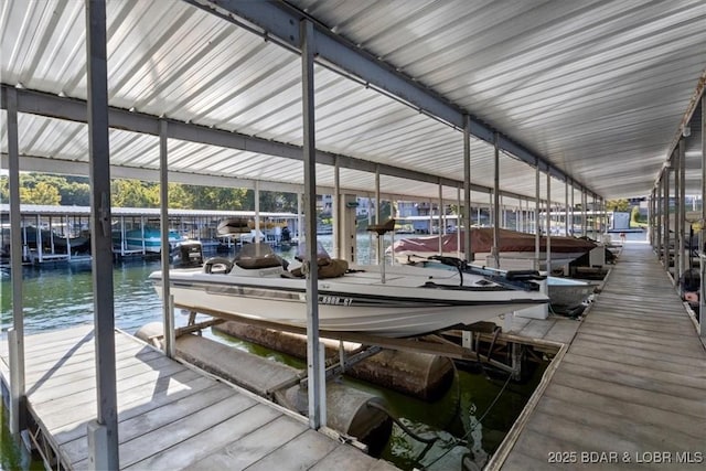 dock area featuring boat lift and a water view