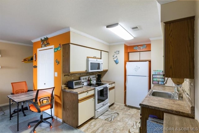 kitchen featuring white appliances, a sink, decorative backsplash, white cabinets, and crown molding