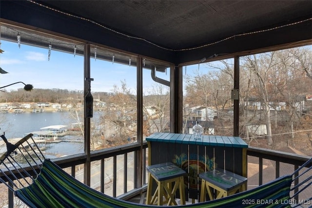 sunroom / solarium with a water view