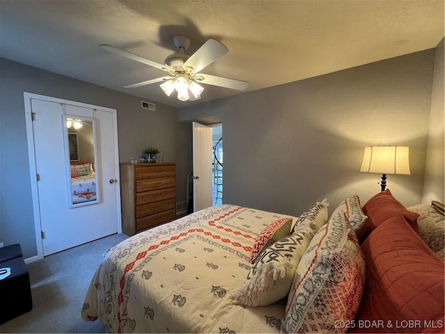 bedroom with carpet flooring, a ceiling fan, and visible vents