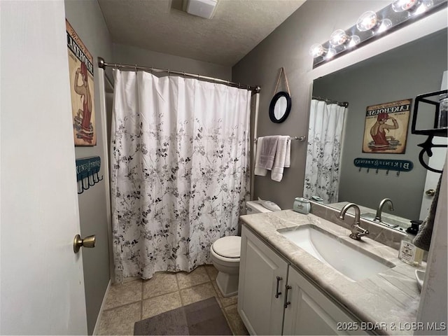 bathroom featuring tile patterned floors, a shower with curtain, toilet, a textured ceiling, and vanity