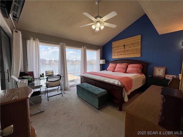 bedroom featuring carpet, ceiling fan, vaulted ceiling, a water view, and access to outside