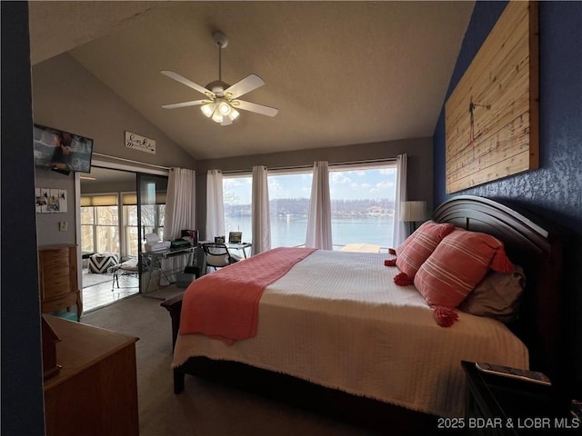 carpeted bedroom with multiple windows, a water view, access to exterior, and vaulted ceiling