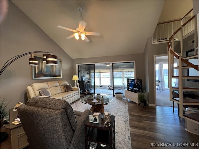 living room featuring high vaulted ceiling, baseboards, dark wood-type flooring, and a ceiling fan