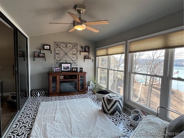 living area featuring a ceiling fan and vaulted ceiling