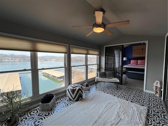 bedroom with vaulted ceiling, a water view, and ceiling fan